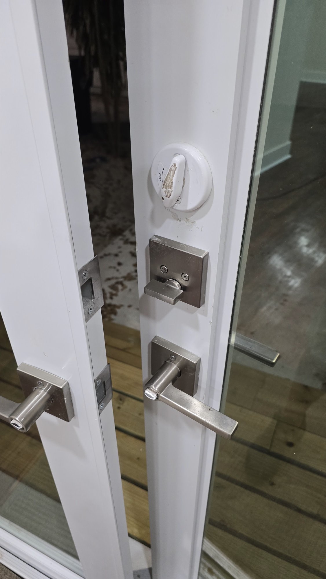New lock and lever hardware on a white patio door