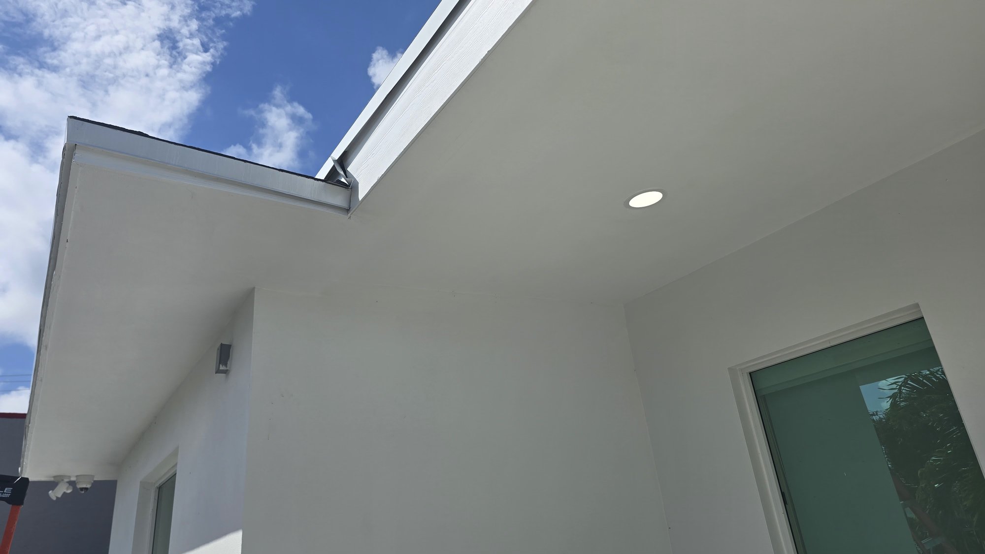 Freshly painted white exterior soffit and wall