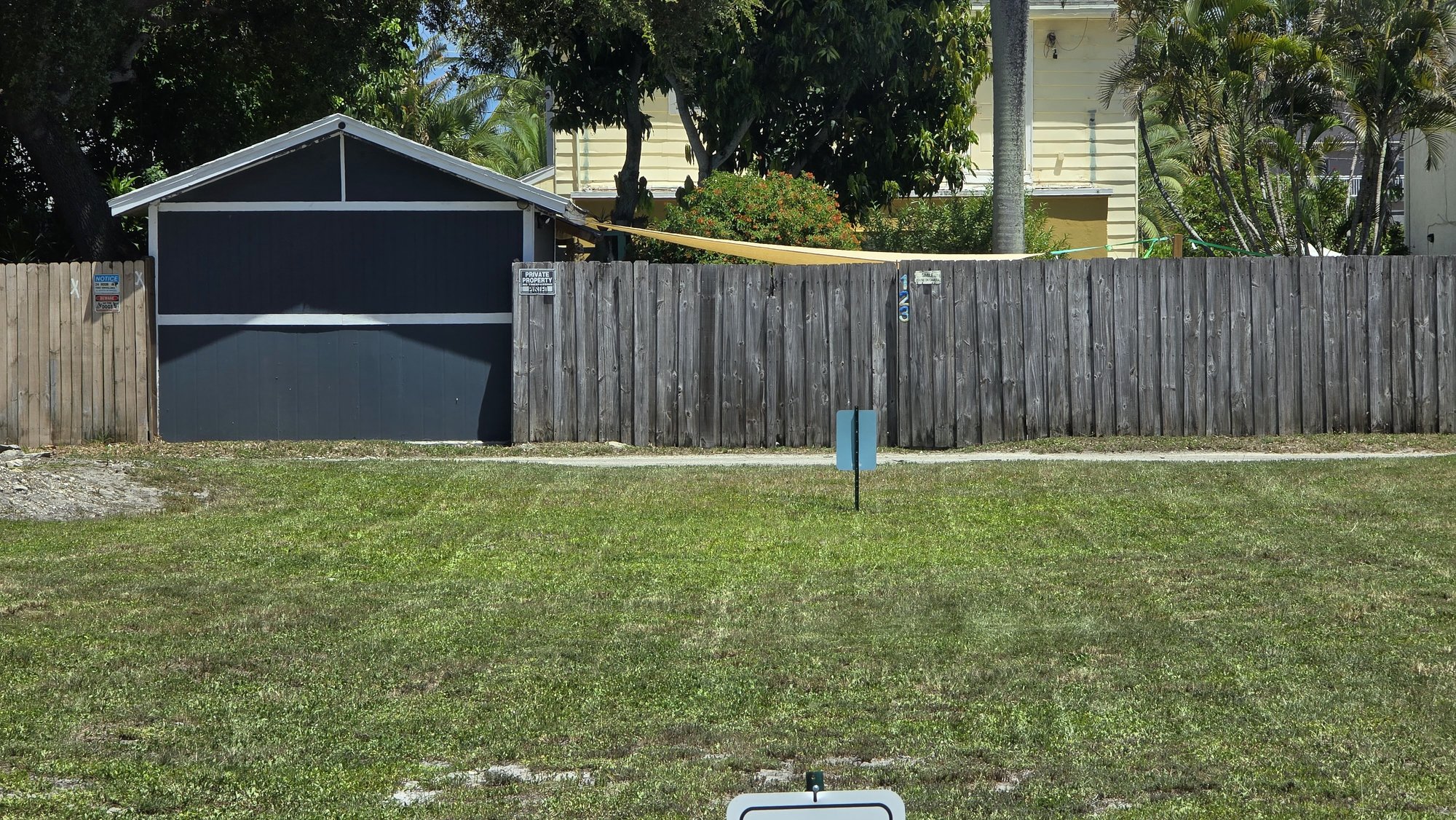 Finished wood fence along a backyard