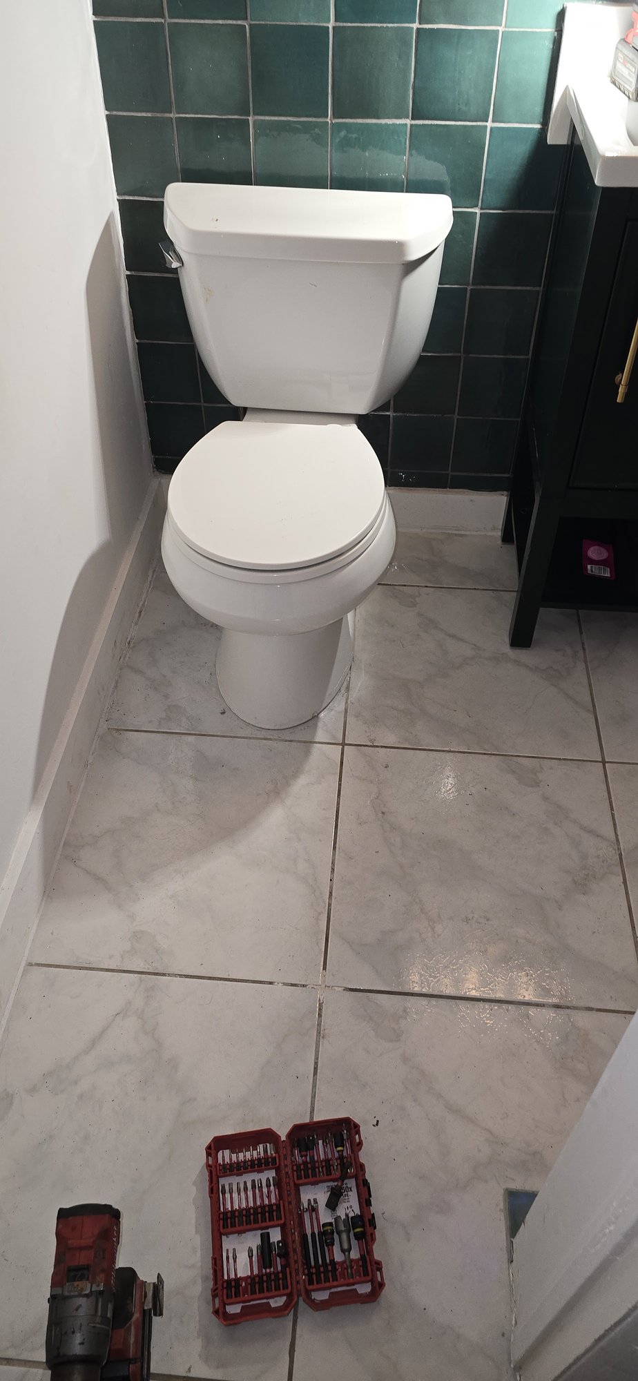 Newly installed toilet in a tiled bathroom