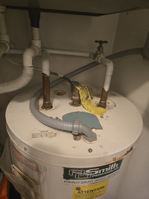 Installed water heater with supply lines